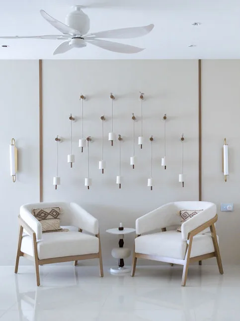 Living room nook with curved accent chairs and ceramic bells - Beautiful Homes